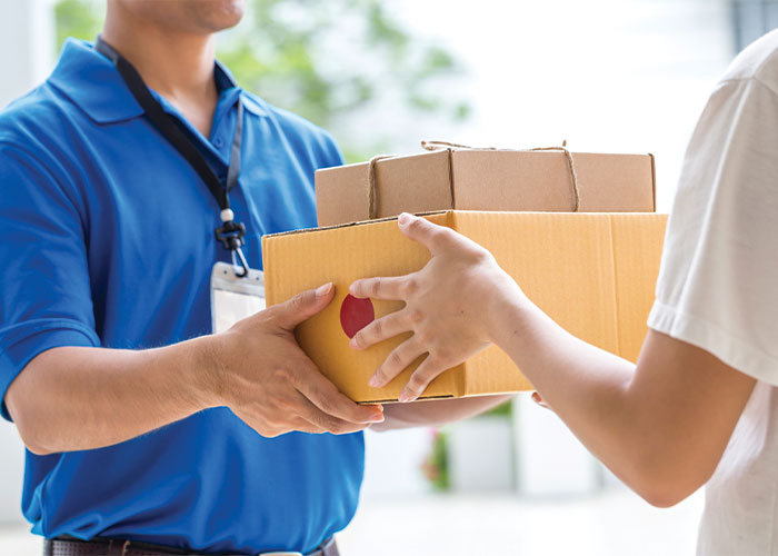 man delivering packages to a doorstep